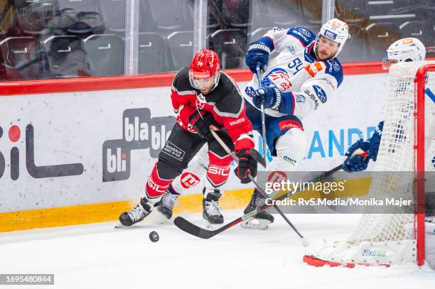 Jason Fuchs of Lausanne HC battles for the puck with Christian Marti of ZSC Lions during the Swiss National League game between Lausanne HC and ZSC...