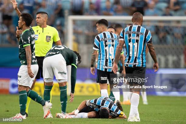 Luis Suárez of Gremio lies injured during Campeonato Brasileiro Serie A match between Gremio and Palmeiras at Arena do Gremio on September 21, 2023...