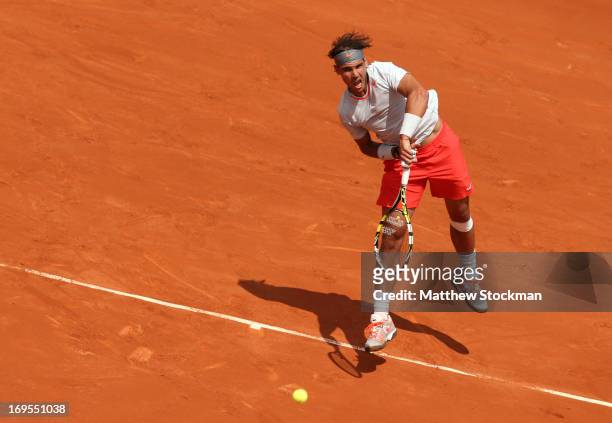 Rafael Nadal of Spain serves in his Men's Singles match against Daniel Brands of Germany during day two of the French Open at Roland Garros on May...