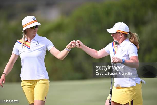Madelene Sagstrom of Team Europe fist bumps Gemma Dryburgh of Team Europe on the eighth green during Day One of The Solheim Cup at Finca Cortesin...