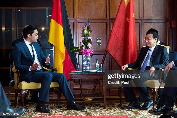 Economics Minister Rosler Phillp greets Chinese Prime Minister Li Keqiang during a lunchtime reception for German and Chinese business...