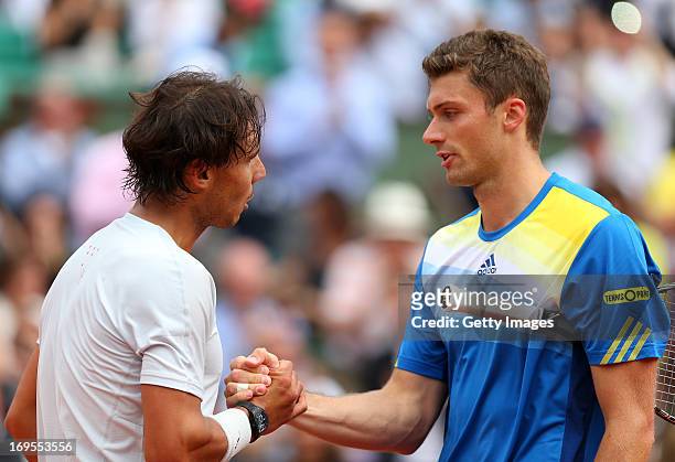 Daniel Brands of Germany congratulates Rafael Nadal of Spain on victory in their Men's Singles match during day two of the French Open at Roland...