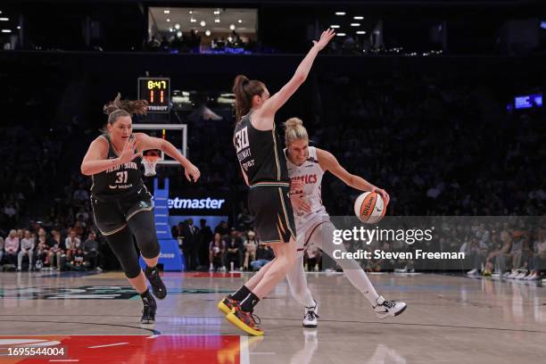 Elena Delle Donne of the Washington Mystics drives to the basket while Breanna Stewart of the New York Liberty and Stefanie Dolson of the New York...