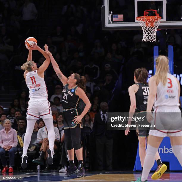 Elena Delle Donne of the Washington Mystics shoots the ball while Stefanie Dolson of the New York Liberty plays defense on September 10, 2023 in...