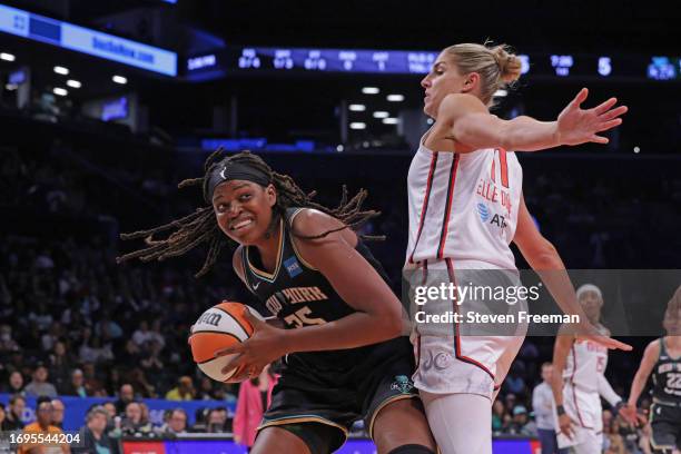 Jonquel Jones of the New York Liberty handles the ball while Elena Delle Donne of the Washington Mystics plays defense during the Washington Mystics...