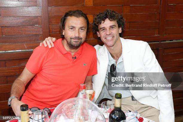 Former Tennis Players Henri Leconte and Gustavo Kuerten attend Roland Garros Tennis French Open 2013 - Day 2 on May 27, 2013 in Paris, France.