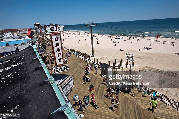 People walk on the boardwalk on the first weekend of Jersey Shore beaches re-opening to the public on May 27, 2013 in Seaside Heights, New Jersey....