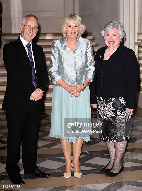 Camilla, Duchess of Cornwall greets Ambassador Sir Peter Ricketts and his wife Lady Suzanne Ricketts as she arrives at a reception at the British...