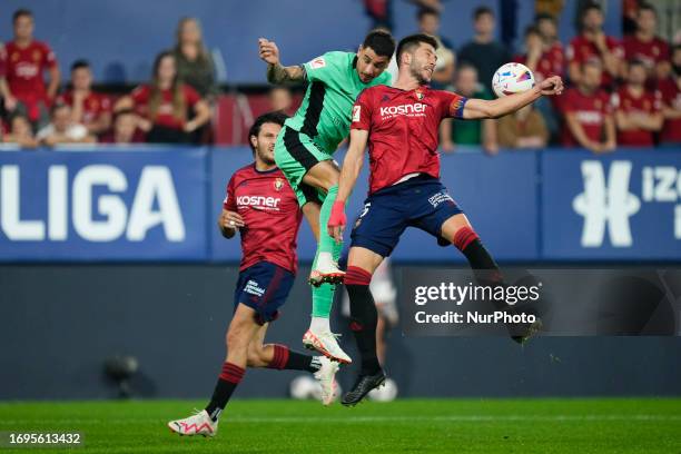 Jose Maria Gimenez centre-back of Atletico de Madrid and Uruguay and David Garcia centre-back of Osasuna and Spain compete for the ball during the...