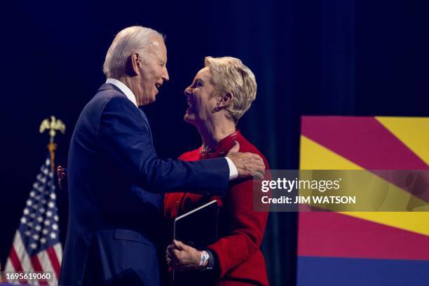 President Joe Biden embraces Cindy McCain as he arrives to deliver remarks on democracy, while honoring the legacy of late US Senator John McCain, at...