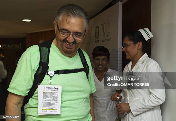 Jose Salvador Perez , the first patient in Latin America to receive a Ventricular Assist Device , jokes with nurses Bianey Garcia and Maritza Barajas...