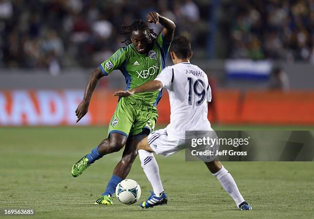 Shalrie Joseph of Seattle Sounders FC is defended by Juninho of the Los Angeles Galaxy at The Home Depot Center on May 26, 2013 in Carson, California.