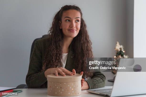 surprised business woman smiling when opening christmas gift - presents 20 years of giving stock pictures, royalty-free photos & images