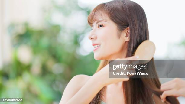 asian happy woman brush hair - hairbrush stock pictures, royalty-free photos & images