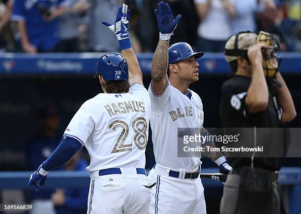 Colby Rasmus of the Toronto Blue Jays is congratulated by Brett Lawrie after hitting a 2-run home run in the second inning during MLB game action...