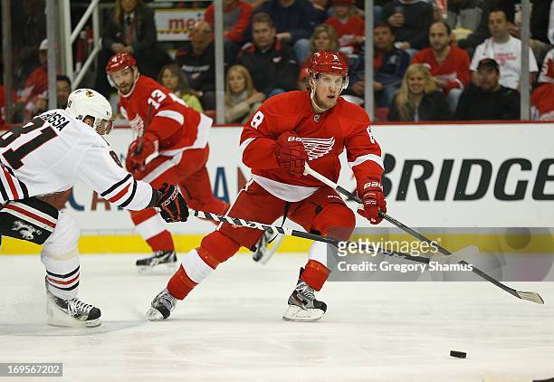 Justin Abdelkader of the Detroit Red Wings tries to avoid the stick of Marian Hossa of the Chicago Blackhawks during the first period in Game Six of...