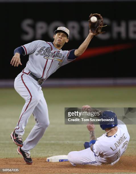 Brett Lawrie of the Toronto Blue Jays steals second base in the sixth inning during MLB game action as Andrelton Simmons of the Atlanta Braves waits...