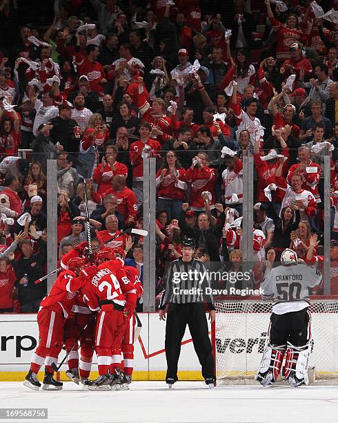 Corey Crawford of the Chicago Blackhawks looks away as Carlo Colaiacovo, Damien Brunner, Gustav Nyquist and Jakub Kindl of the Detroit Red Wings...