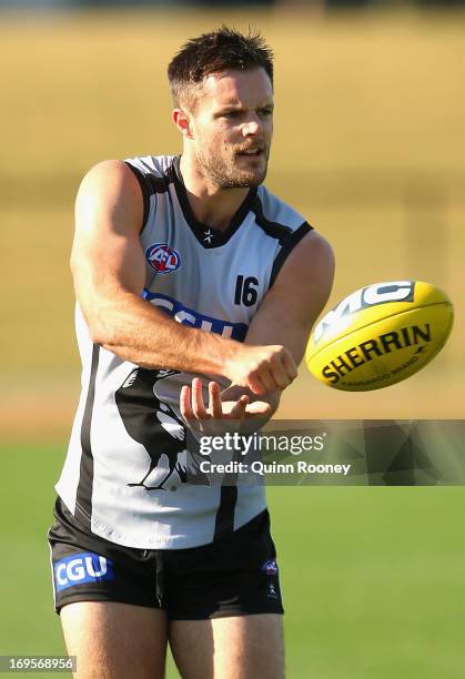 Nathan Brown of the Magpies handballs during a Collingwood Magpies AFL training session at Olympic Park on May 28, 2013 in Melbourne, Australia.