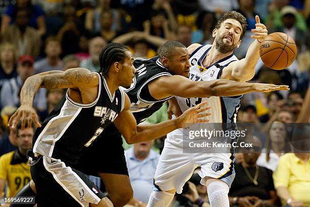 Kawhi Leonard and Boris Diaw of the San Antonio Spurs go after the ball against Marc Gasol of the Memphis Grizzlies in the second quarter during Game...