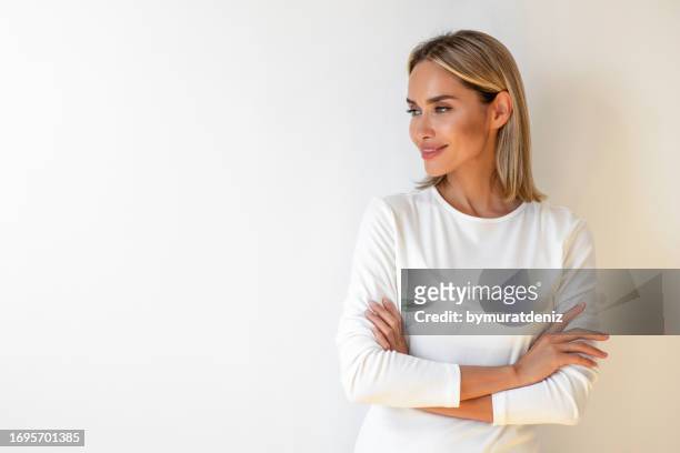 smiling happy woman with arms crossed - beautiful women stock pictures, royalty-free photos & images
