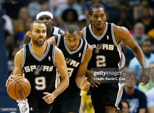 Tony Parker of the San Antonio Spurs moves the ball in front of teammates Boris Diaw and Kawhi Leonard in the second quarter against the Memphis...