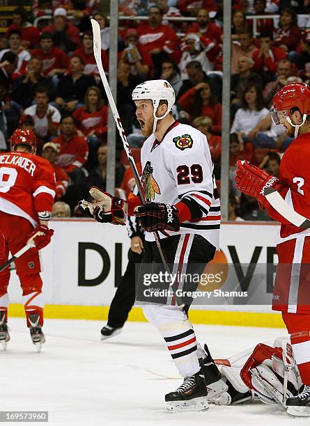 Bryan Bickell of the Chicago Blackhawks reacts to his third period goal in front of Brendan Smith of the Detroit Red Wings in Game Six of the Western...