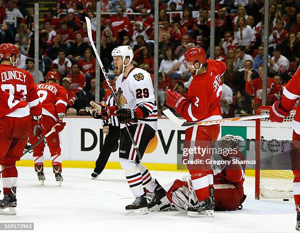 Bryan Bickell of the Chicago Blackhawks reacts to his third period goal in front of Jimmy Howard and Brendan Smith of the Detroit Red Wings in Game...