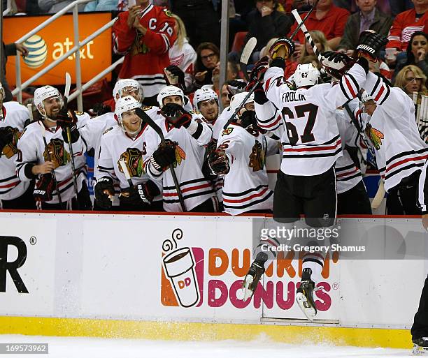 Michael Frolik of the Chicago Blackhawks celebrates his third period penalty shot goal with his teammates while playing the Detroit Red Wings in Game...