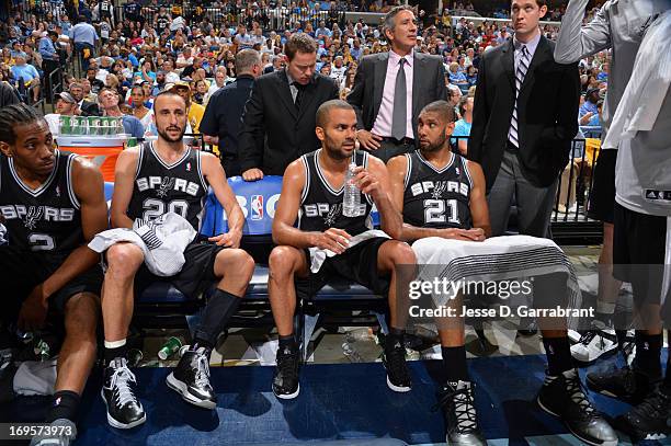 Manu Ginobili ,Tony Parker and Tim Duncan of the San Antonio Spurs talk things over on the bench against the Memphis Grizzlies in Game Four of the...