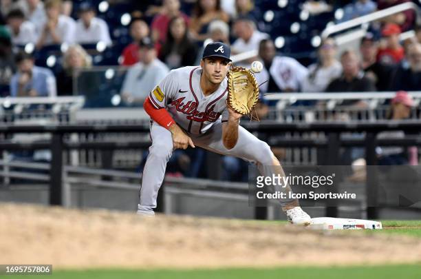 Atlanta Braves first baseman Matt Olsen takes a throw at first base with his first basemans glove mitt during the Atlanta Braves versus Washington...