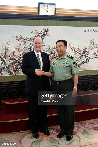 National Security Adviser Tom Donilon shakes hands with Vice Chairman of China's Central Military Commission, General Fan Changlong during their...