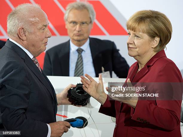 Of Mennekes Elektrotechnik GmbH, Walter Mennekes talks with German Chancellor Angela Merkel at the Electro-Mobility Conference at the Berlin Congress...