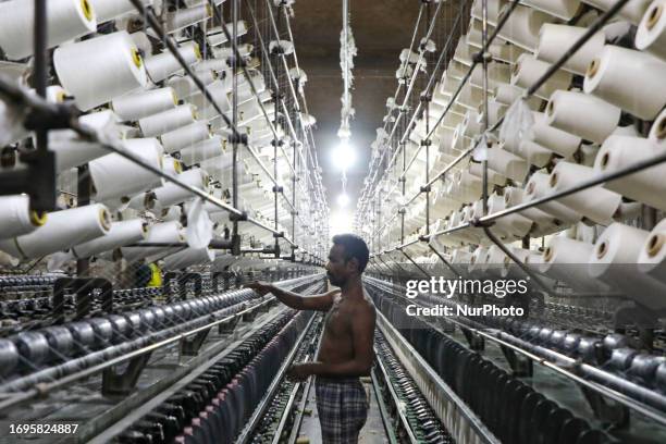 Workers manufacture thread for Ready-Made Garment Industry in a textile mill in Narayanganj outskirts of Dhaka, Bangladesh on September 02, 2023.