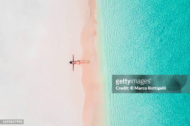 aerial view of tourist relaxing on beach of the caribbean sea, mexico - caribbean dream stock pictures, royalty-free photos & images