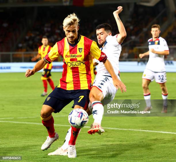 Pontus Almqvist of Lecce competes for the ball with Aaron Martin of Genoa during the Serie A TIM match between US Lecce and Genoa CFC at Stadio Via...