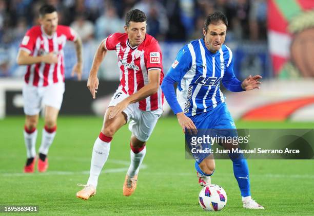 Kike of Deportivo Alaves is put under pressure by Mikel Vesga of Athletic Club during the LaLiga EA Sports match between Deportivo Alaves and...