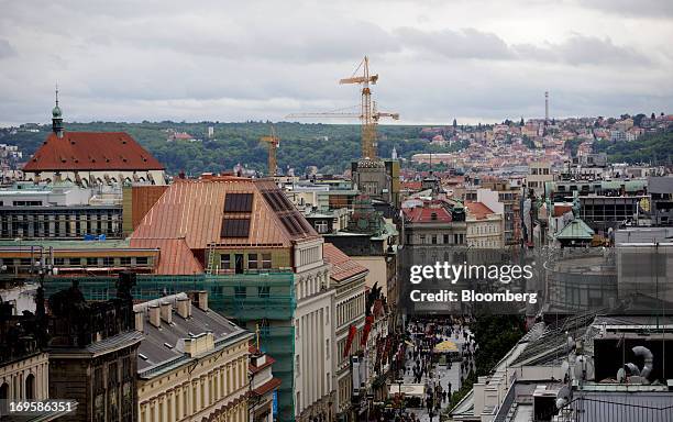 Construction cranes stand above the skyline in the city center in Prague, Czech Republic, on Monday, May 27, 2013. Czech policy makers are in...