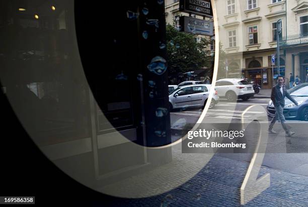 An O2 logo sits in the window of a Telefonica Czech Republic AS retail store in Prague, Czech Republic, on Monday, May 27, 2013. Czech policy makers...