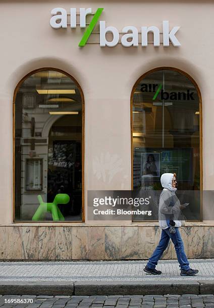Pedestrian passes the window display of an Air Bank branch in Prague, Czech Republic, on Monday, May 27, 2013. Czech policy makers are in uncharted...