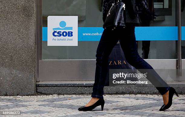 Pedestrian carries a Zara shopping bag past a branch of CSOB AB, the Czech unit of KBC Groep NV bank, in Prague, Czech Republic, on Monday, May 27,...