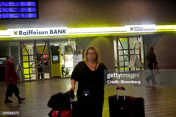 Pedestrians pass a Raiffeisen Bank International AG bank branch at Hlavni Nadrazi railway station in Prague, Czech Republic, on Monday, May 27, 2013....