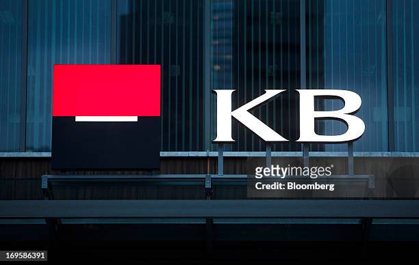 Logo sits on display outside a Komercni Banka AS bank branch in Prague, Czech Republic, on Monday, May 27, 2013. Czech policy makers are in uncharted...