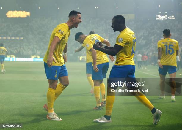 Cristiano Ronaldo of Al-Nassr Club celebrates with :Sadio Mane of Al Nassr Club after scoring his teams first goal during the Saudi Pro League match...