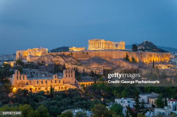 acropolis in athens, greece at dusk - acropolis athens stock pictures, royalty-free photos & images