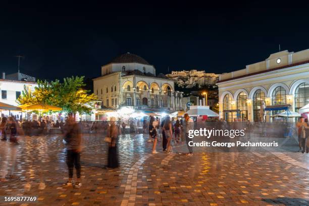 people in monastiraki square, athens, greece at night - athens night fotografías e imágenes de stock