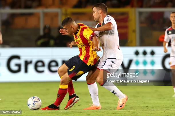 Nikola Krstovic of Lecce competes for the ball with Kevin Strootman of Genoa during the Serie A TIM match between US Lecce and Genoa CFC at Stadio...