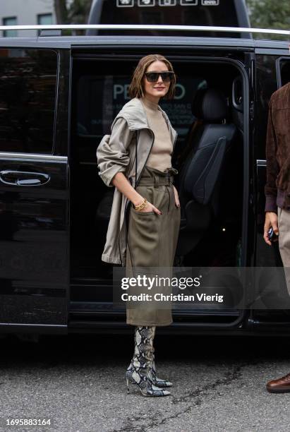 Olivia Palermo wears green skirt, jacket, beige jumper, snake print boots outside Tods during the Milan Fashion Week - Womenswear Spring/Summer 2024...