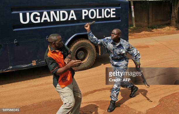 An Uganda policeman beats up a journalist in Kampala, on May 28 outside the Daily Monitor and Red Pepper newspapers, which were closed on May 20 by...
