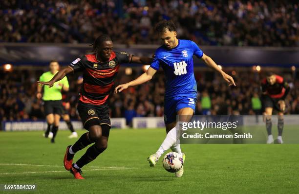 Ethan Laird of Birmingham City is challenged by Osman Kakay of Queens Park Rangers during the Sky Bet Championship match between Birmingham City and...